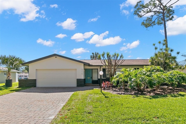 single story home featuring central AC, a garage, and a front lawn