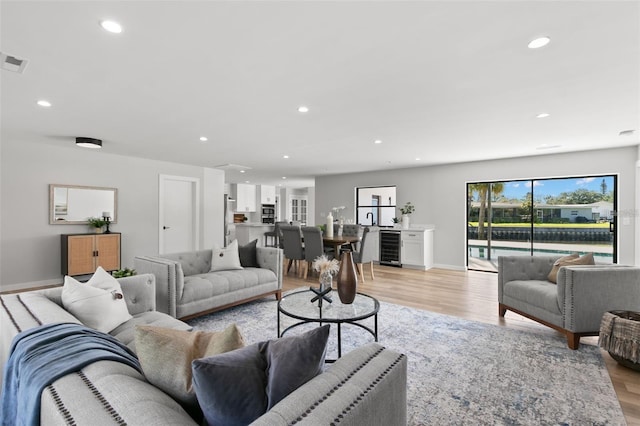 living room featuring light hardwood / wood-style flooring and beverage cooler