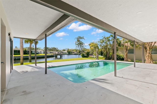 view of swimming pool featuring a water view and a patio area