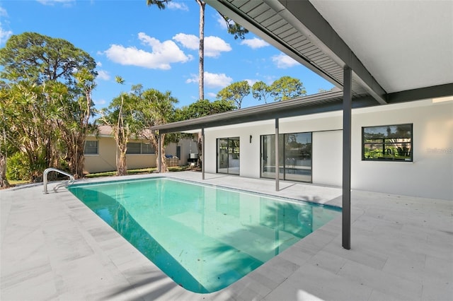 view of swimming pool with a patio