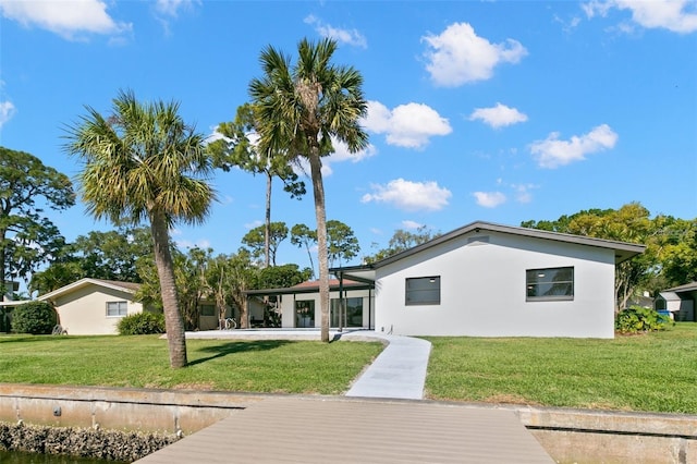 back of property featuring a lawn