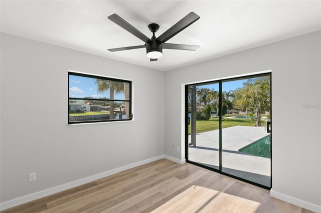 unfurnished room with ceiling fan and light wood-type flooring