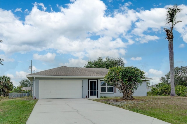 ranch-style house featuring a garage and a front lawn