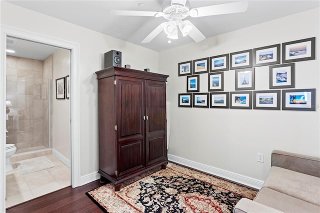 interior space with ceiling fan and dark hardwood / wood-style flooring