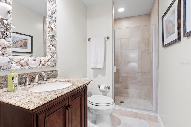 bathroom featuring tile patterned floors, toilet, a shower with shower door, and vanity