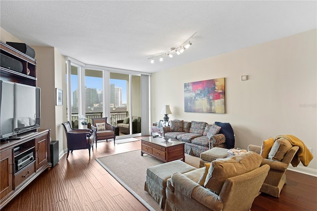 living room with hardwood / wood-style floors and a textured ceiling