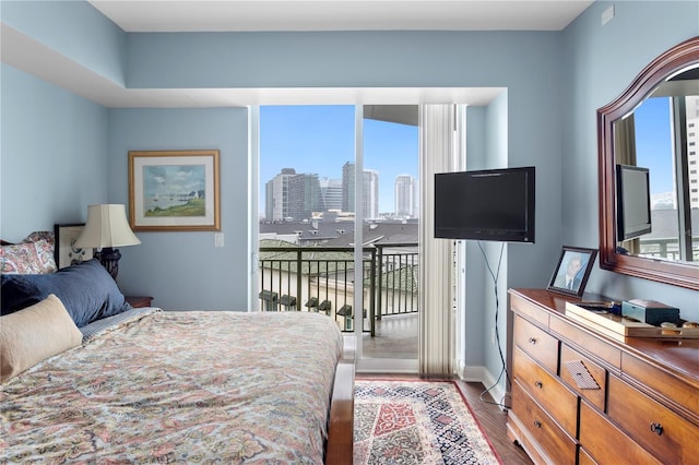 bedroom featuring access to exterior and light wood-type flooring