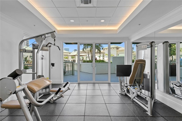 workout area featuring a raised ceiling