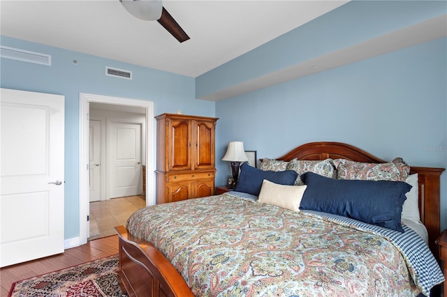 bedroom with light hardwood / wood-style flooring and ceiling fan