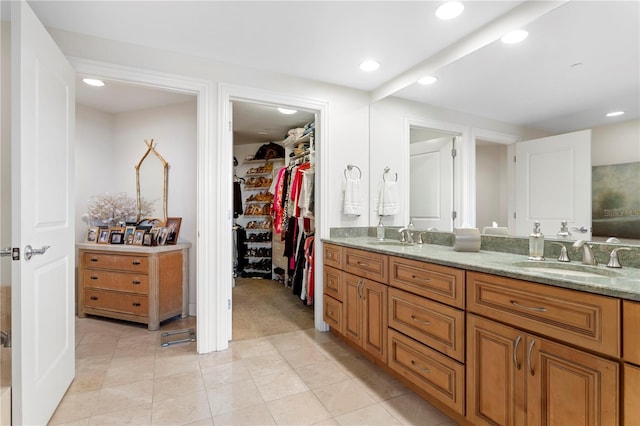 bathroom featuring tile patterned flooring and vanity