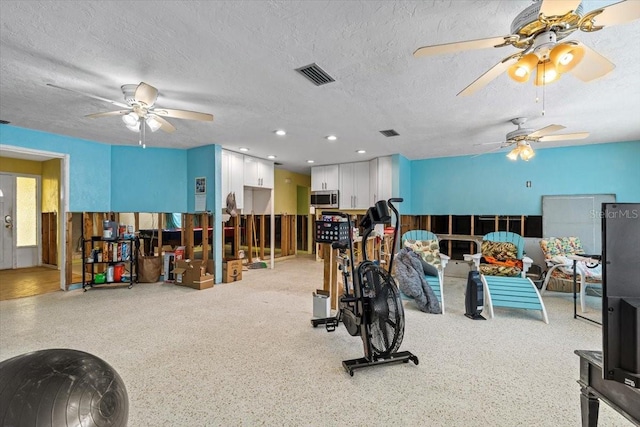 exercise room featuring a textured ceiling