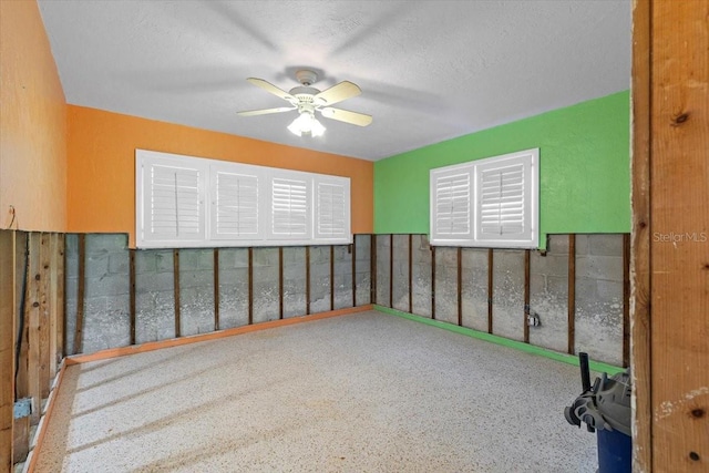 spare room featuring a textured ceiling and ceiling fan