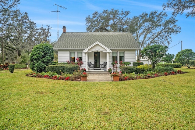 view of front of property with a chimney and a front yard