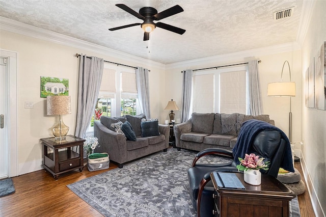 living room with dark hardwood / wood-style flooring, ornamental molding, ceiling fan, and a textured ceiling