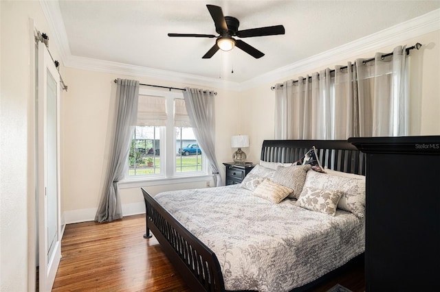 bedroom featuring ornamental molding, hardwood / wood-style floors, and ceiling fan