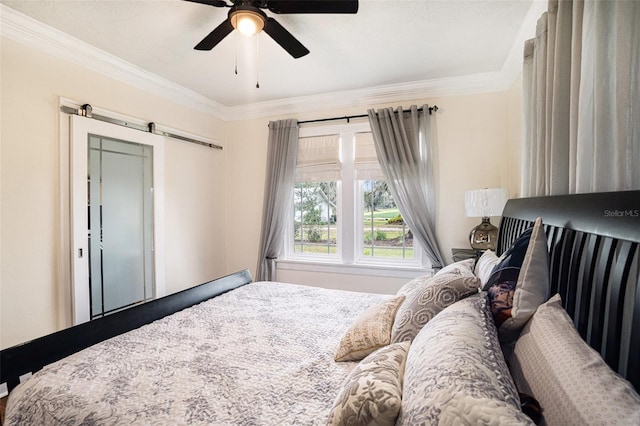 bedroom with crown molding, a barn door, and ceiling fan