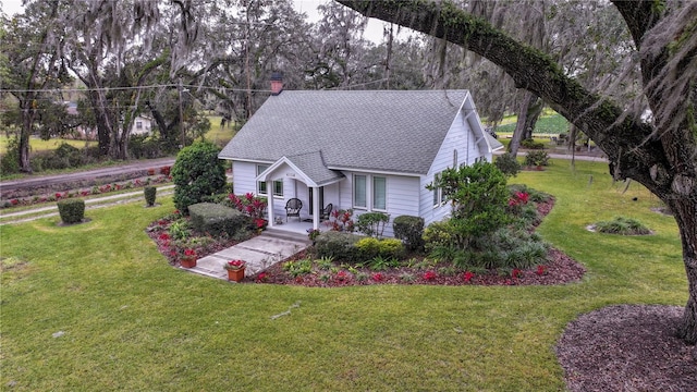 view of front facade with a front yard and covered porch