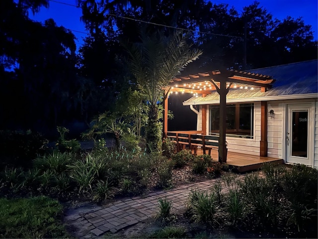 exterior space featuring a wooden deck and a pergola