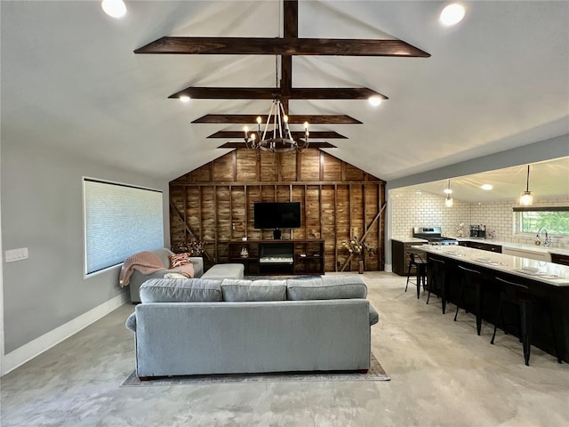 living room with sink, beam ceiling, wooden walls, and high vaulted ceiling