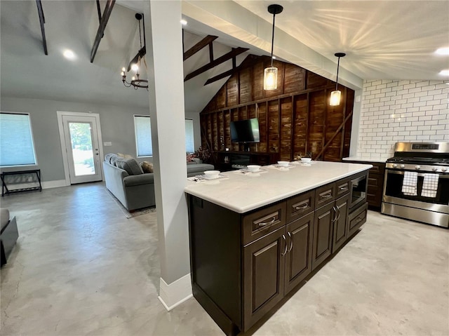 kitchen featuring wooden walls, stainless steel appliances, dark brown cabinetry, lofted ceiling with beams, and decorative light fixtures