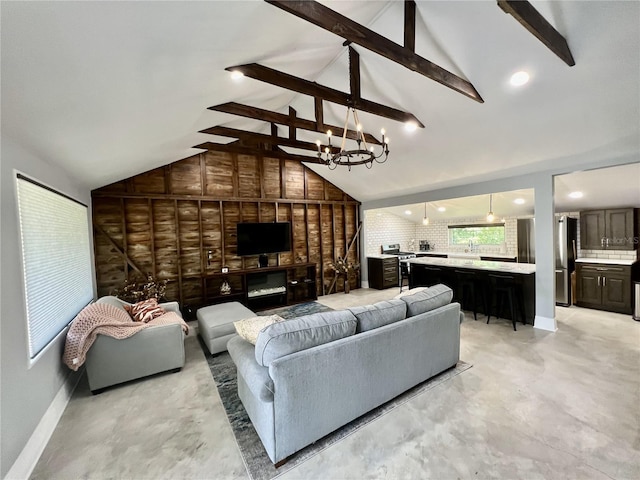 living room with wooden walls, high vaulted ceiling, beam ceiling, and a notable chandelier