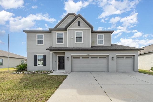 view of front of home featuring a front yard and a garage