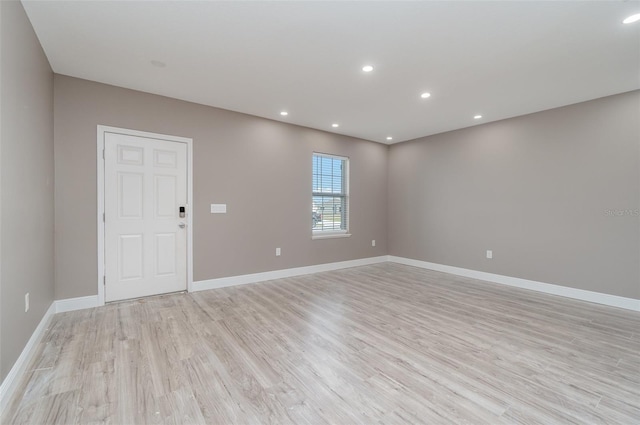 unfurnished room with light wood-type flooring