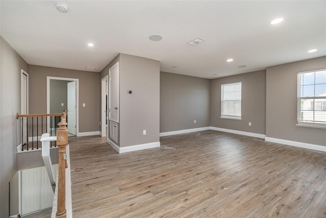 empty room with light hardwood / wood-style flooring