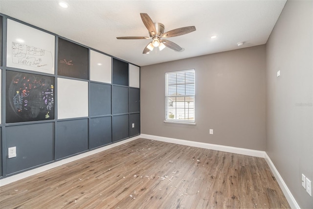 empty room featuring ceiling fan and hardwood / wood-style floors