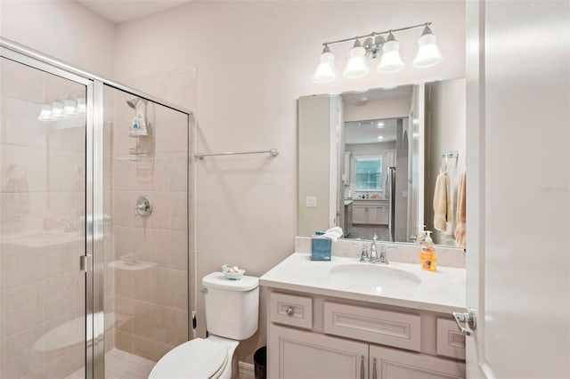 bathroom featuring vanity, toilet, and walk in shower