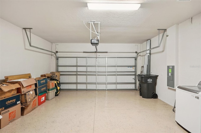 garage featuring a garage door opener, washer / dryer, and electric panel