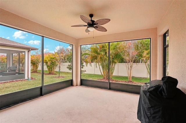 sunroom featuring ceiling fan