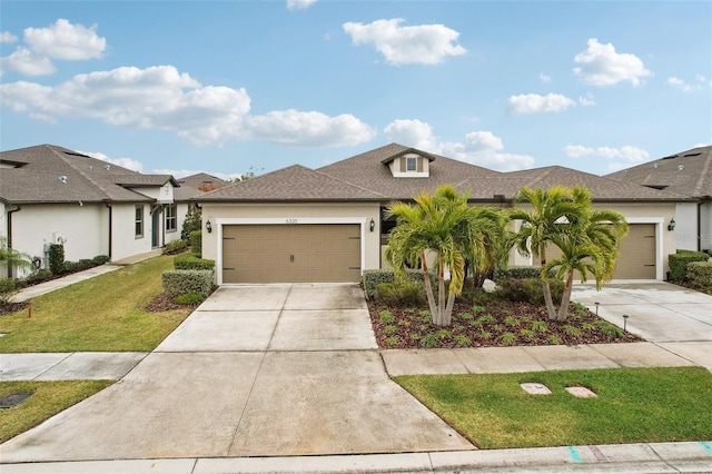 view of front of property with a garage and a front yard