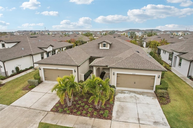 view of front of house featuring a garage and a front yard