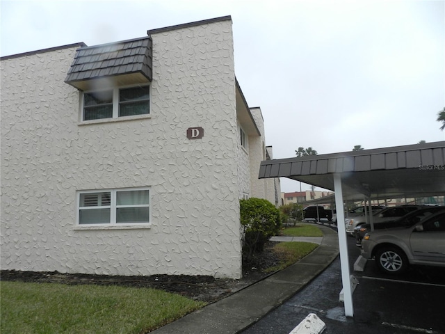 view of property exterior with a carport