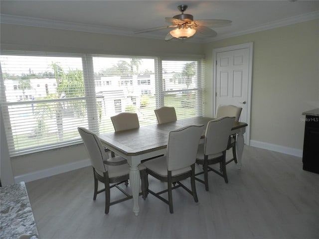 dining room featuring crown molding, wood-type flooring, and ceiling fan