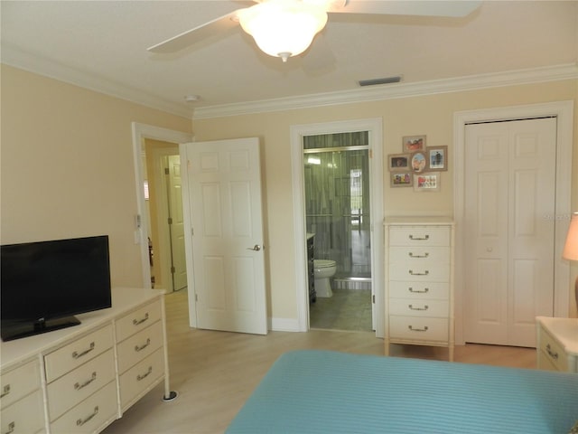 bedroom featuring a closet, ornamental molding, ceiling fan, ensuite bath, and light hardwood / wood-style flooring