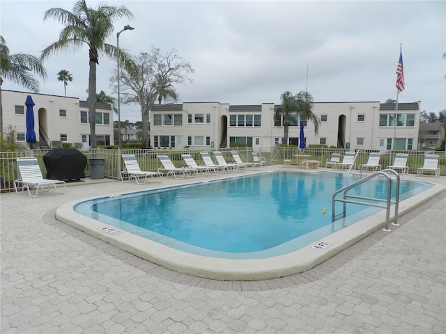 view of swimming pool featuring area for grilling and a patio area