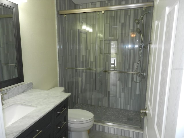 bathroom featuring vanity, toilet, and walk in shower