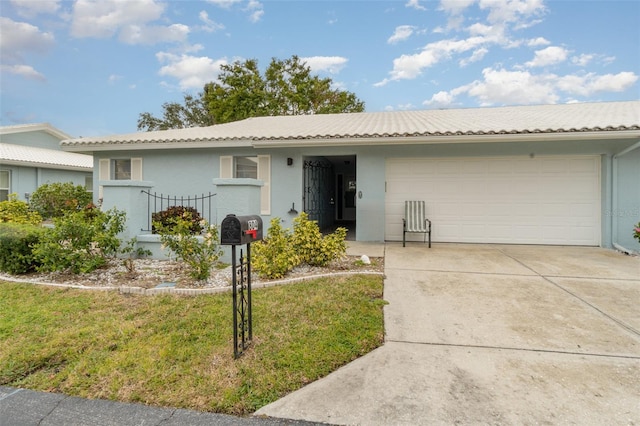 ranch-style house with stucco siding, concrete driveway, a garage, a tiled roof, and a front lawn