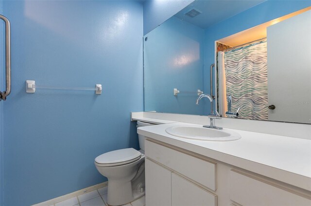 bathroom featuring baseboards, visible vents, toilet, tile patterned floors, and vanity