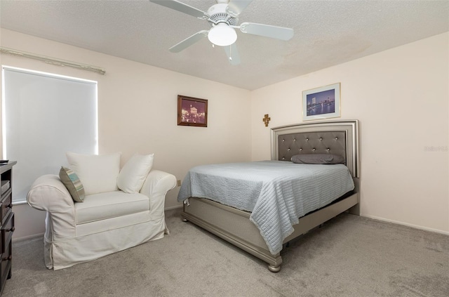 bedroom featuring a textured ceiling, ceiling fan, carpet, and baseboards