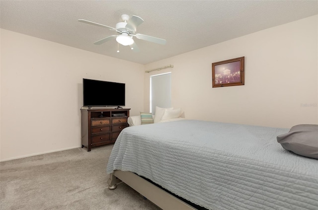 bedroom with a textured ceiling, ceiling fan, and light colored carpet