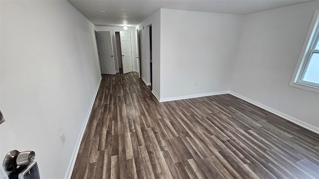 spare room with dark hardwood / wood-style flooring