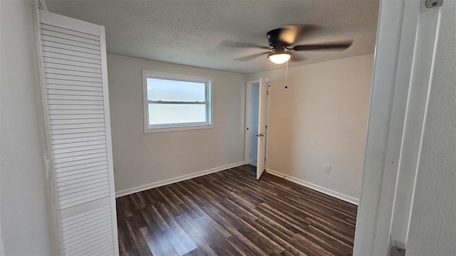 unfurnished bedroom featuring dark hardwood / wood-style floors, a textured ceiling, and ceiling fan