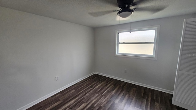 spare room featuring ceiling fan and dark hardwood / wood-style flooring