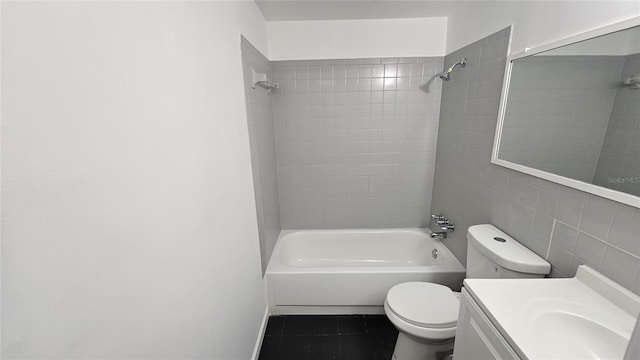 full bathroom featuring tile walls, tiled shower / bath combo, vanity, tile patterned floors, and toilet