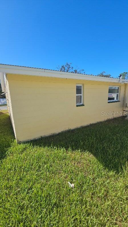 view of side of home featuring a yard