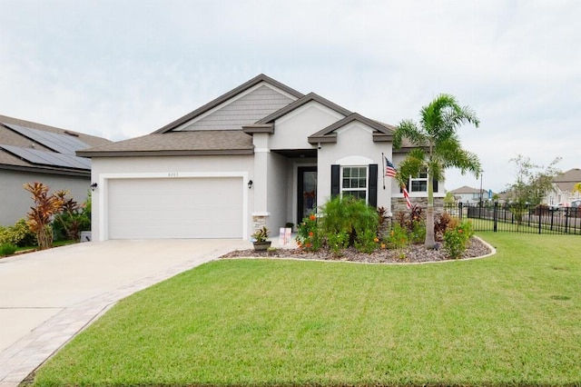 view of front of home featuring a garage and a front yard