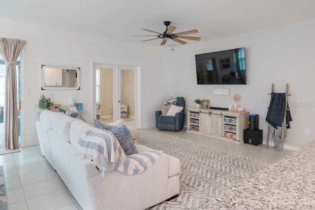 living room with ceiling fan and light tile patterned floors